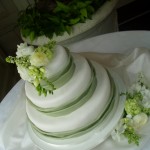 Green and White Wedding Cake with Fresh Flowers