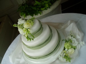 Green and White Wedding Cake with Fresh Flowers