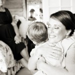 Image of bride hugging child