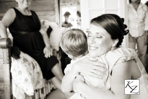 Image of bride hugging child Image of bride hugging child