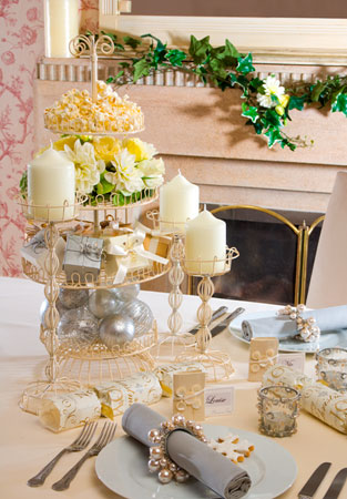 This table decor has cream yellow silver green and blue in a shabby chic 